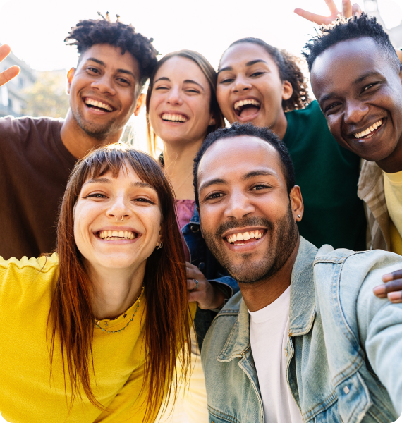 A group of diverse happy friends smiling together taking a selfie